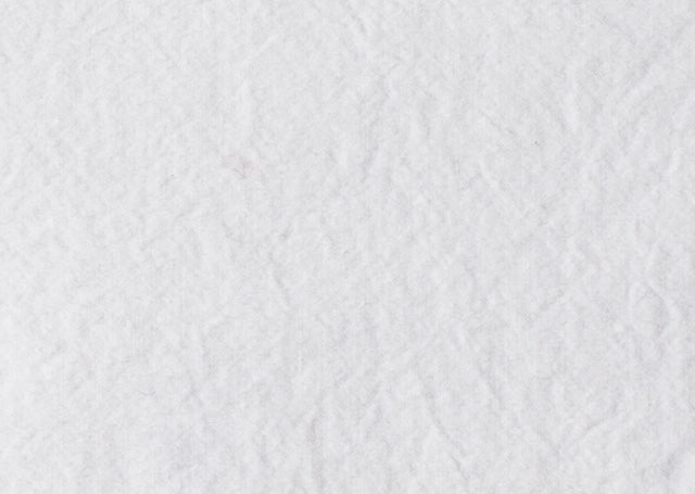 Bettwäsche Bianco Gewaschene Baumwolle: Nahaufnahme der hochwertigen, vorgewaschenen Baumwollbettwäsche in strahlendem Weiß mit charakteristischer, leicht strukturierter Oberfläche und natürlich-lässiger Knitteroptik. Die butterweiche Textur und feine Webstruktur sind deutlich erkennbar.
